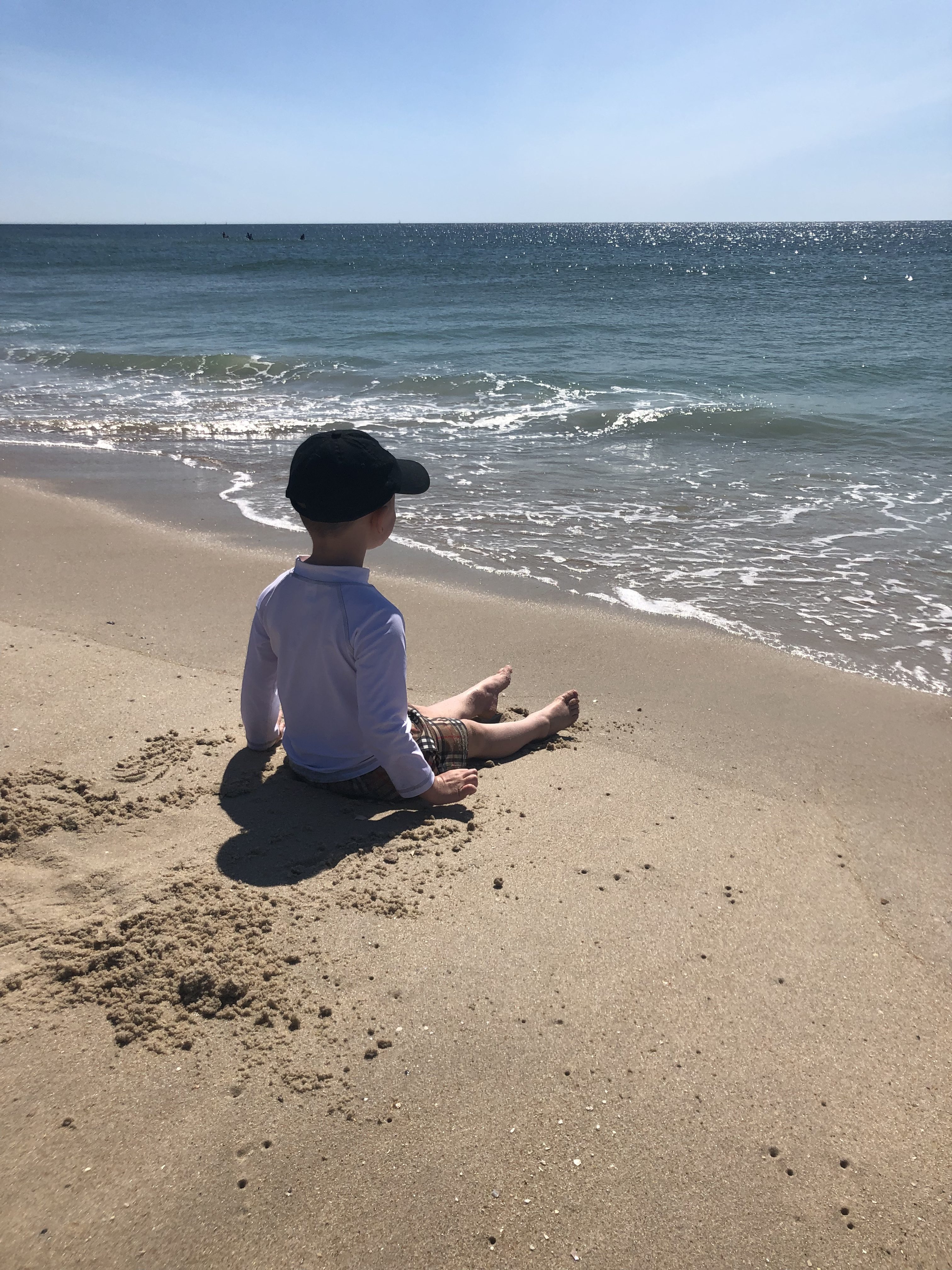 kid sitting at the shore