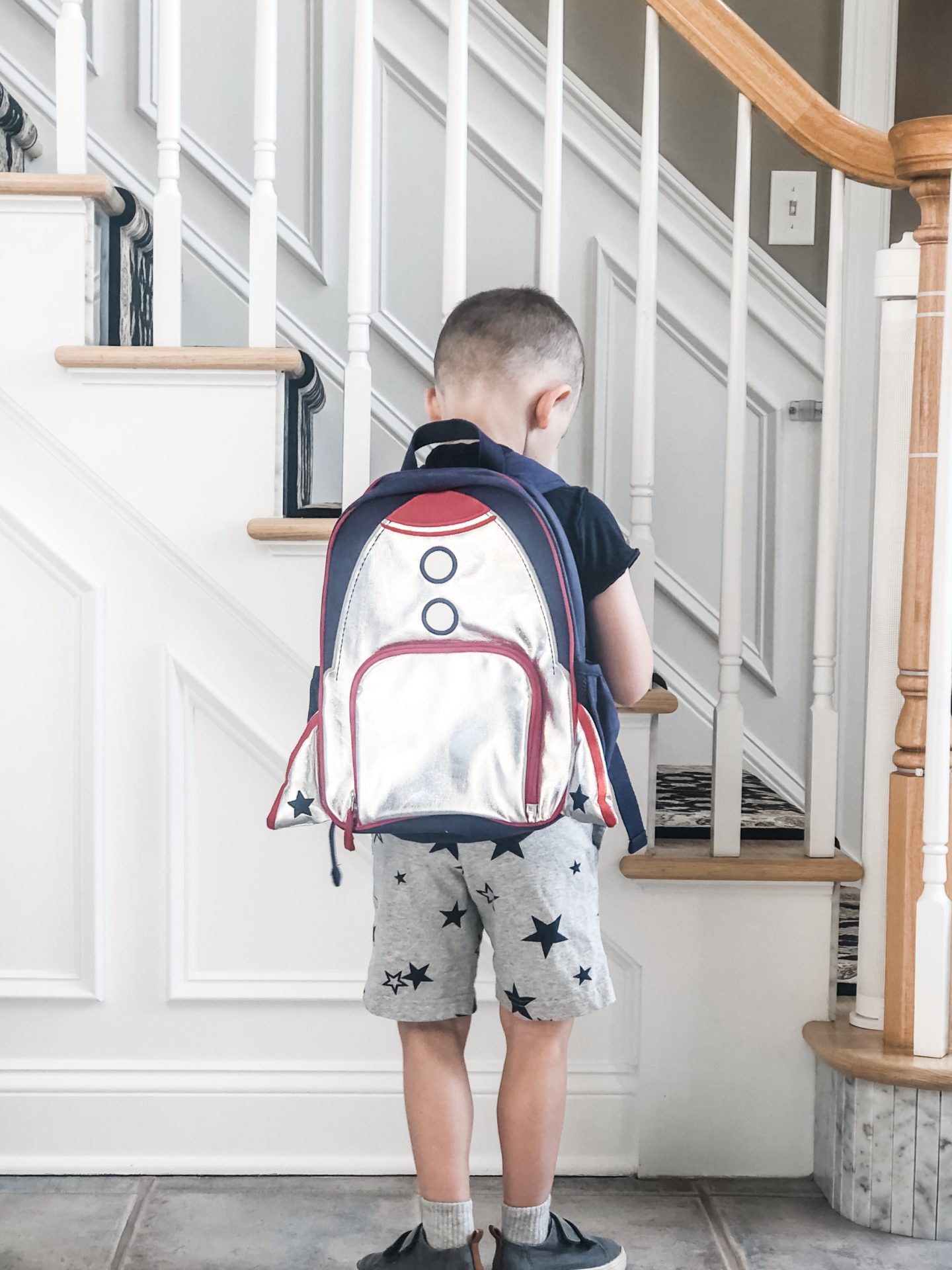 kid showing backpack for back to school essentials