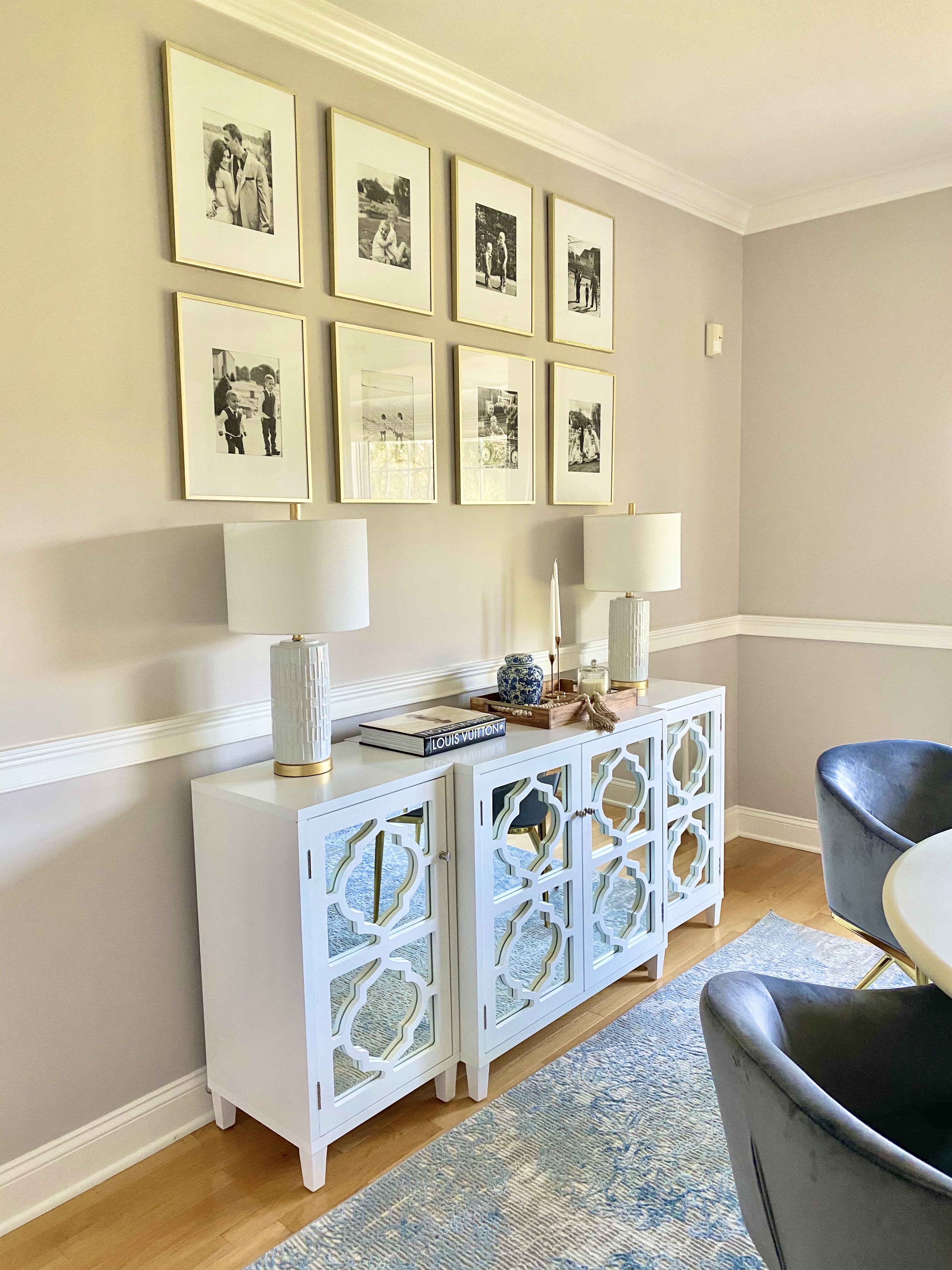 china cabinet in white with framed photos on top