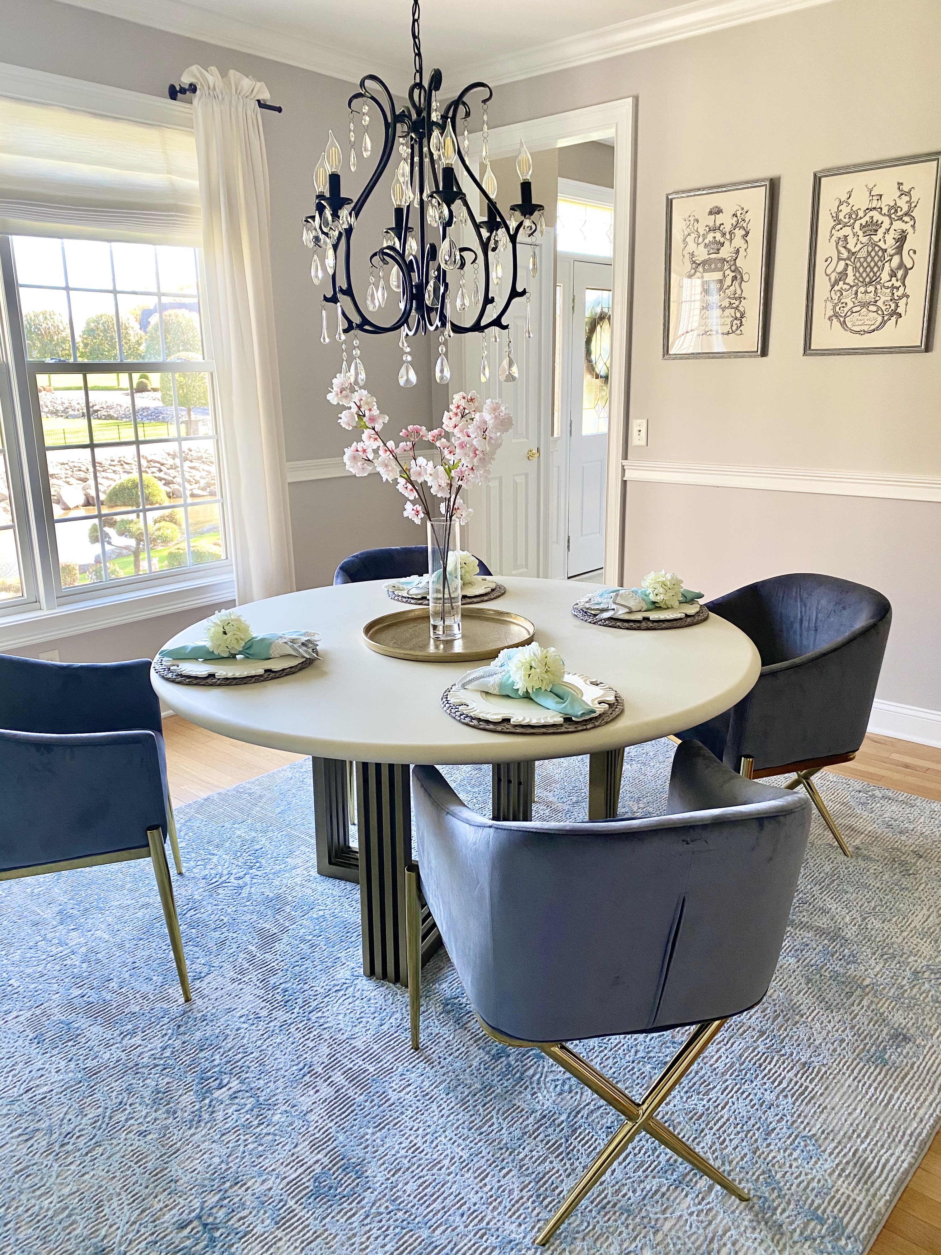 Dining Room Reveal with round table and four chairs, chandelier, and flowers