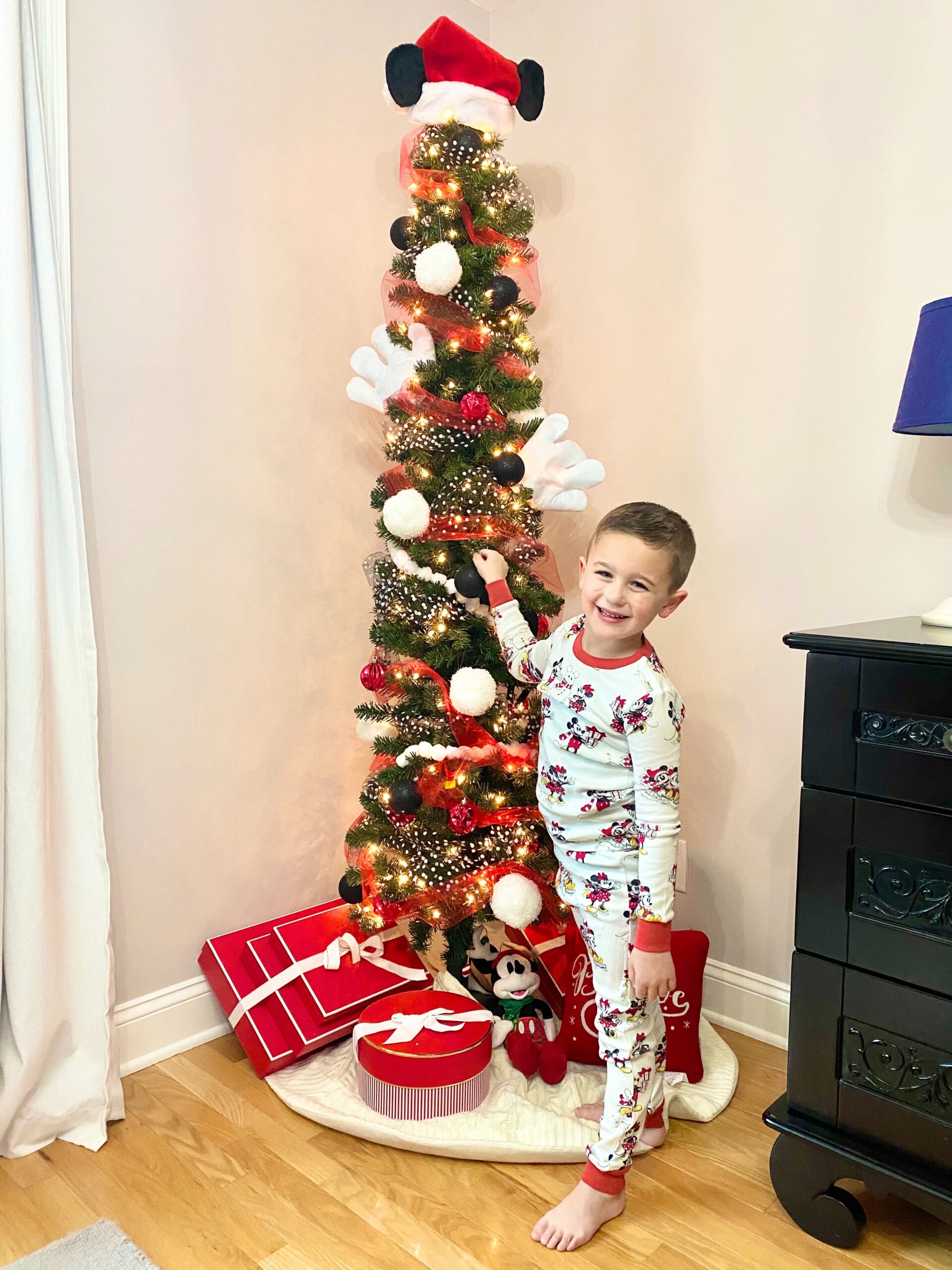 kid standing near the Christmas tree