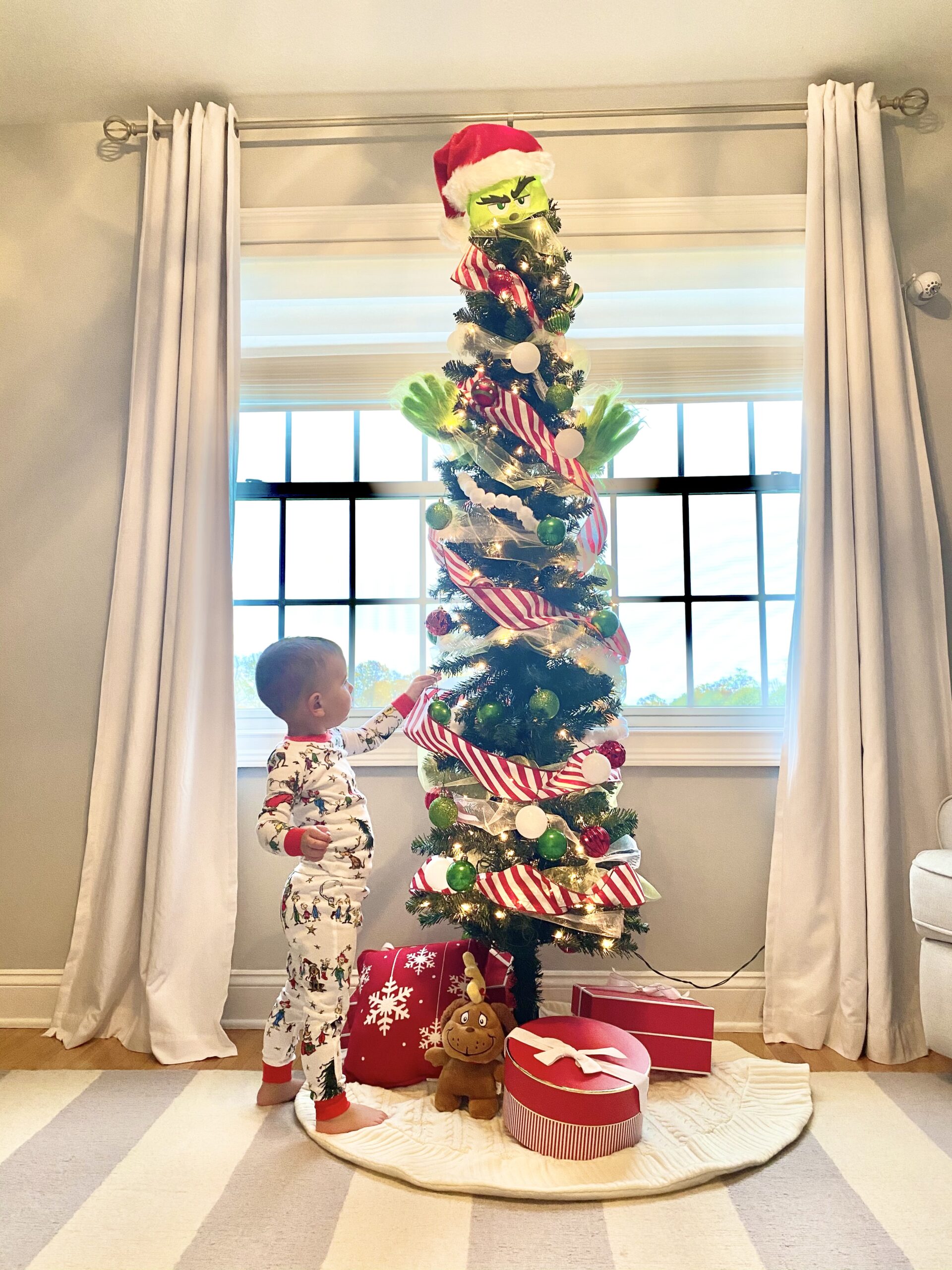 kid decorating Christmas tree sharing Fun Holiday Inspo For Kids