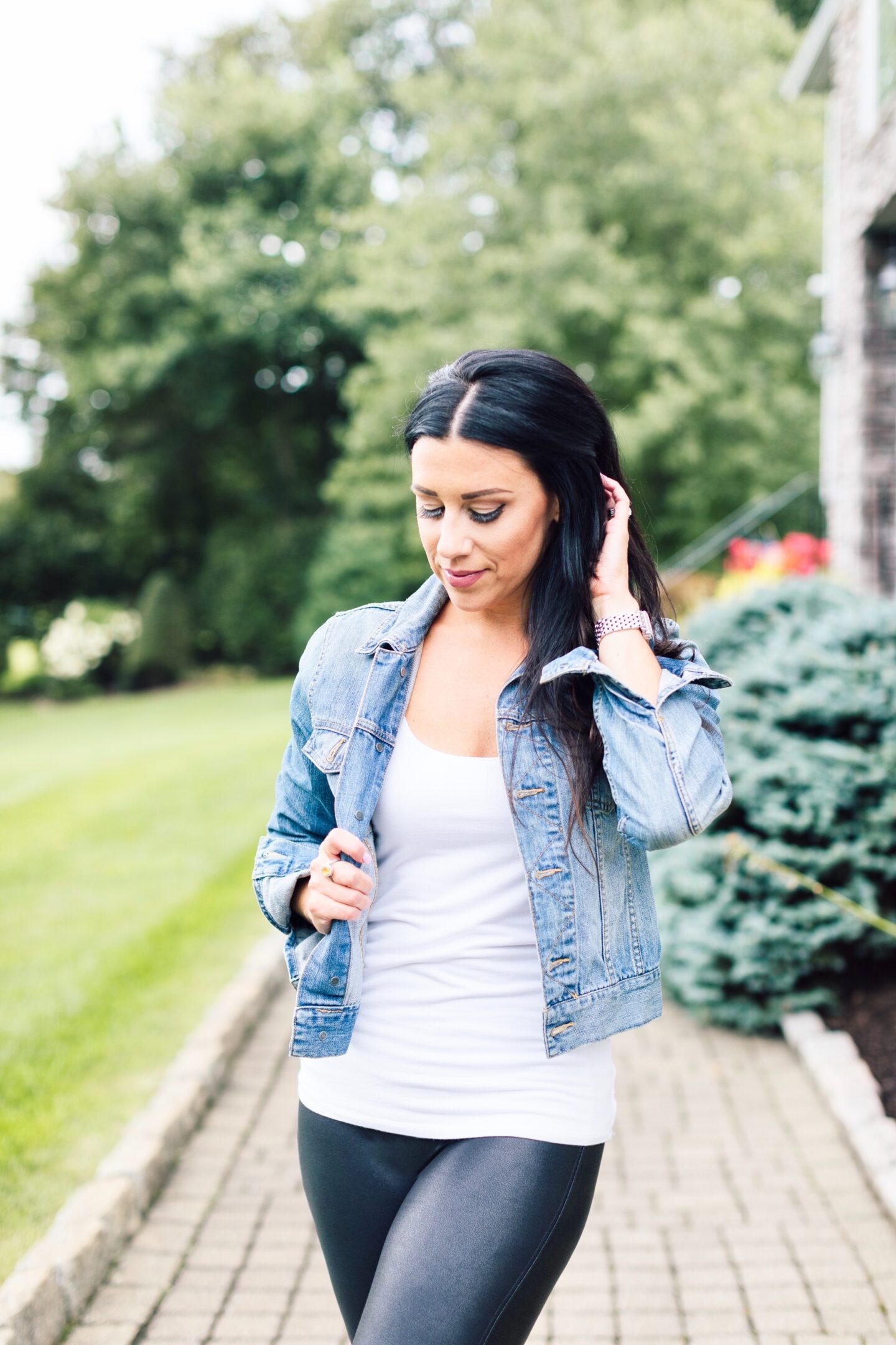 woman wearing white top and black leggings for Spring Outerwear Staples