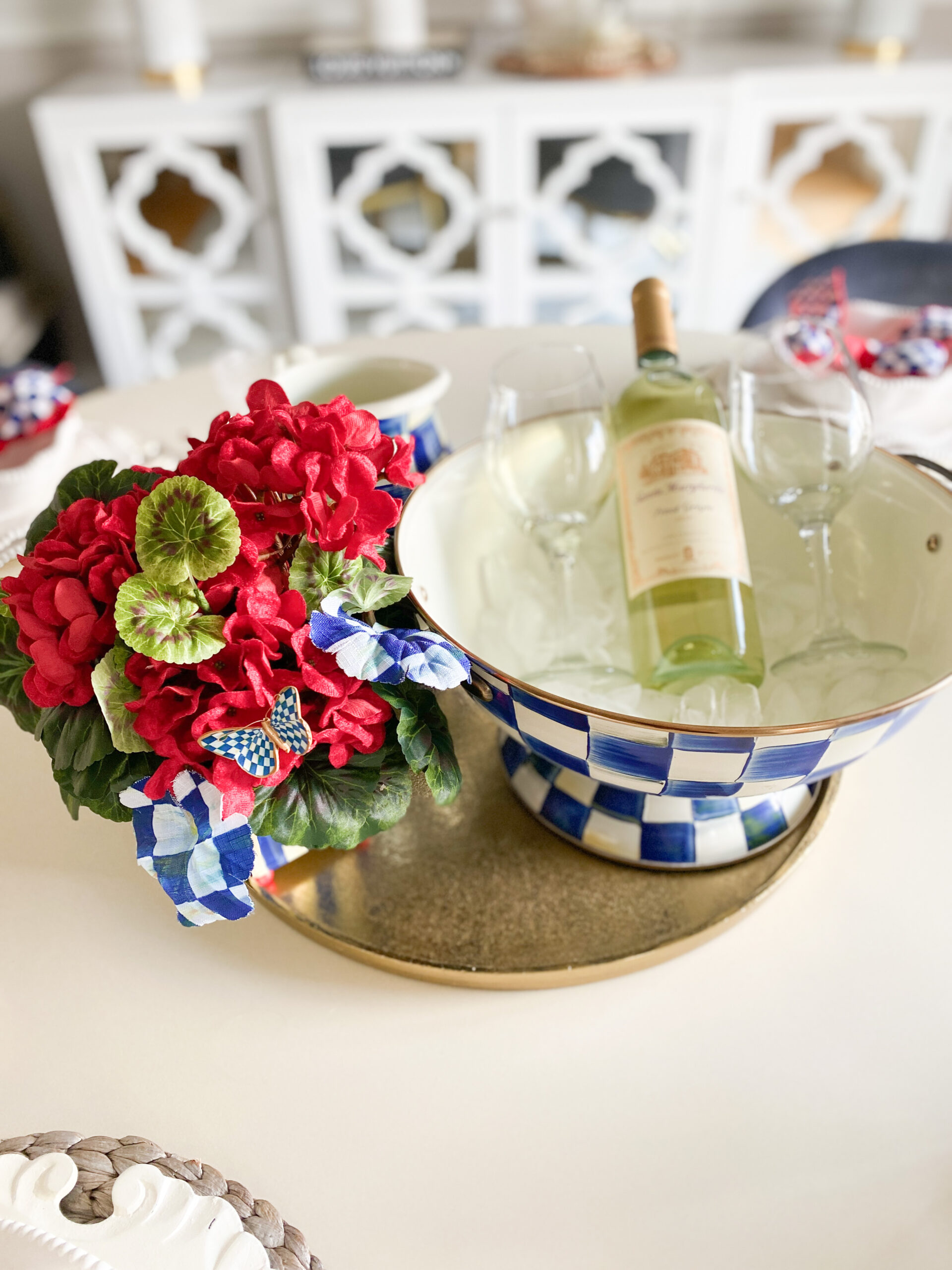 a Summer Tablescape with blue and white theme, wine, wine glasses, and flowers