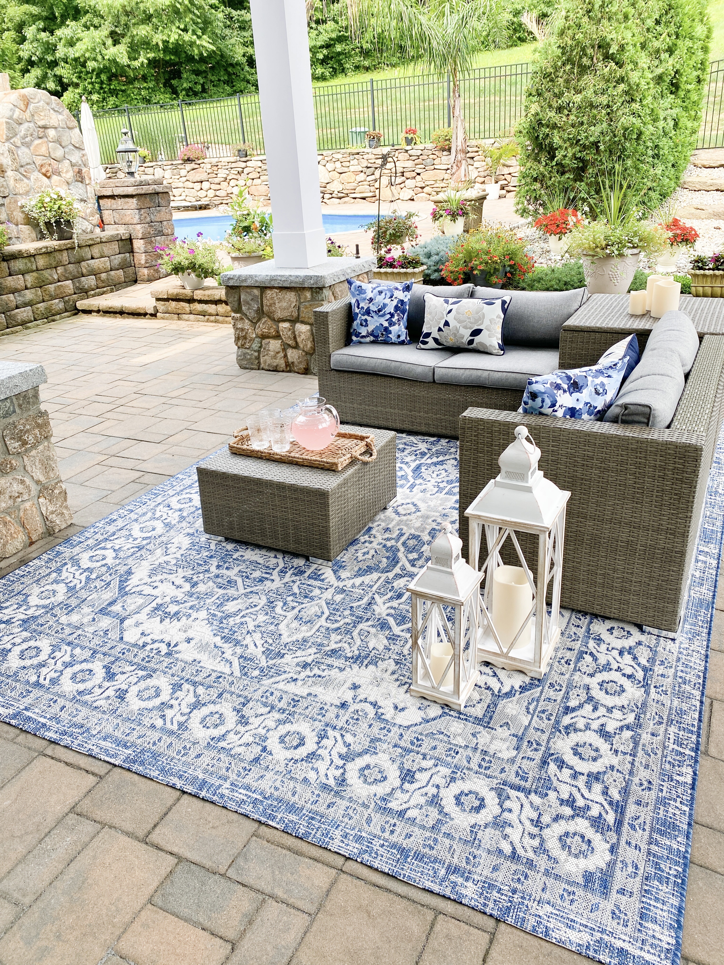 Patio with outdoor furniture and juice and glasses on the table 