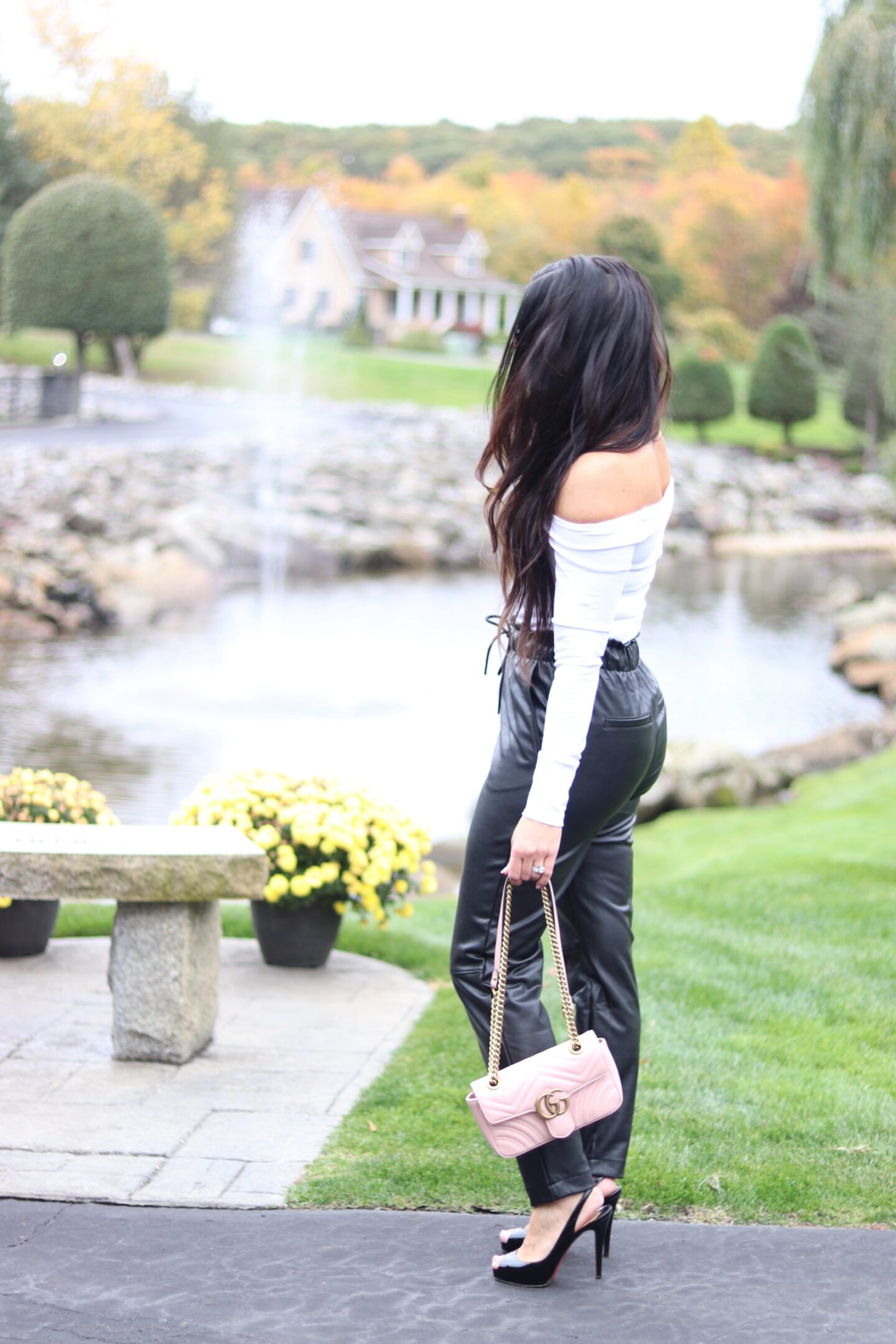 woman in leather pants and white top